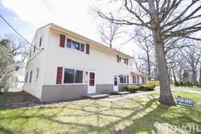 Toledo townhouse for rent - A two-story house with a red door and a "For Rent" sign in front.