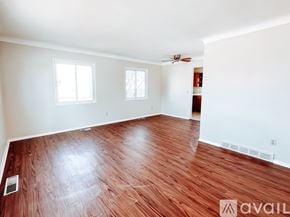 Toledo townhouse for rent - A room with wooden flooring and two windows.
