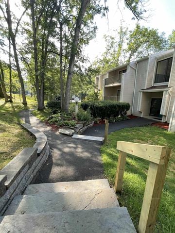 State College apartment for rent - A wooden structure is in the foreground of a residential area with apartment buildings and trees.