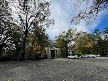 State College apartment for rent - A parking lot with cars and trees in the background.
