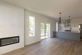 Edmonton apartment for rent - A modern kitchen with a fireplace and wooden floors.