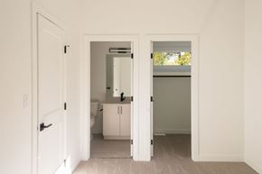 Edmonton apartment for rent - A white bathroom with a toilet, sink, and cabinet.