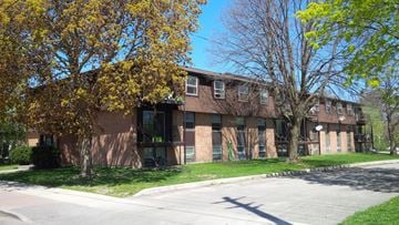 Belleville apartment for rent - Apartment building with a tree in front of it.