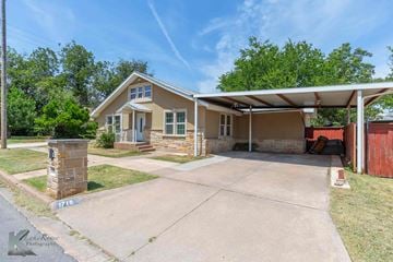Abilene house for rent - A house with a garage and a driveway in front.