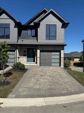London house for rent - A modern house with a grey front yard and a grey driveway.