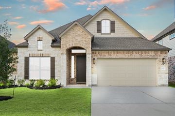Katy house for rent - A house with a garage door and a driveway.