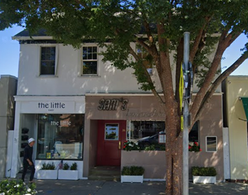 East Hampton apartment for rent - A white building with a red door and a sign that says "The Little".