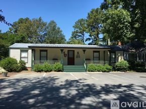 Wilson apartment for rent - A house with a green front porch and a red door.