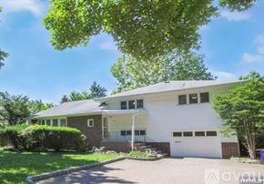 Cresskill house for rent - A white house with a green lawn in front.