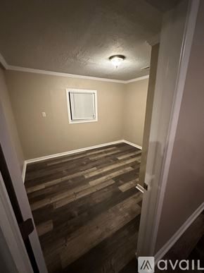 Enid house for rent - A room with wooden stairs leading to a window.