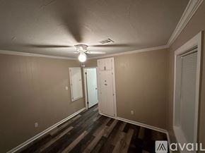 Enid house for rent - A room with a ceiling fan and a row of closets.