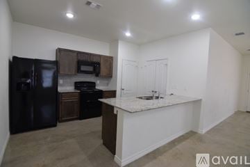 Killeen apartment for rent - A kitchen with black appliances and a white countertop.