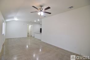 Killeen apartment for rent - A spacious room with a ceiling fan and a light source.