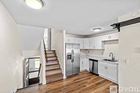 Canton condo for rent - A kitchen with white cabinets and a stainless steel refrigerator.
