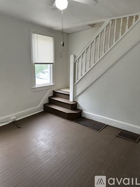 Cumberland townhouse for rent - A room with a staircase and wooden flooring.