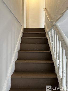 Cumberland townhouse for rent - A staircase with white balusters and brown steps.