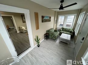 Ventnor City house for rent - A living room with a couch, chair, and a cactus.