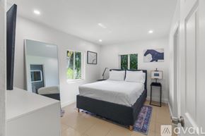 Fort Lauderdale apartment for rent - A bedroom with a large bed and a mirror on the wall.