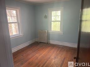 Hopewell house for rent - A room with a wooden floor and a window with a white frame.