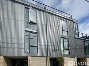 Seattle townhouse for rent - A modern building with a corrugated metal facade and large windows.