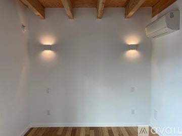 Seattle townhouse for rent - A kitchen with white cabinets and a stainless steel refrigerator.