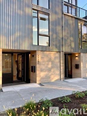 Seattle townhouse for rent - A modern house entrance with a wooden wall and a black door.
