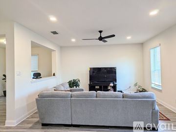 Prosper house for rent - A living room with a grey couch and a television.