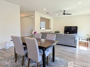 Prosper house for rent - A modern dining room with a wooden table and grey chairs.