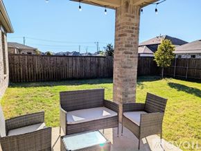 Prosper house for rent - A patio with a table and chairs and a hot tub.