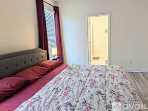 Prosper house for rent - A bedroom with a bed, pillows, and a window with curtains.