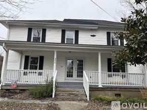 Louisa apartment for rent - A white house with black shutters and a porch.
