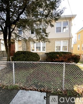 Irvington apartment for rent - A room with wooden floors and a chandelier hanging from the ceiling.