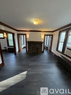 Irvington apartment for rent - A large, empty room with wooden floors and a fireplace.