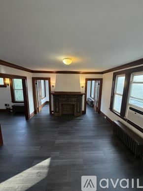 Irvington apartment for rent - A spacious living room with a fireplace and large windows.