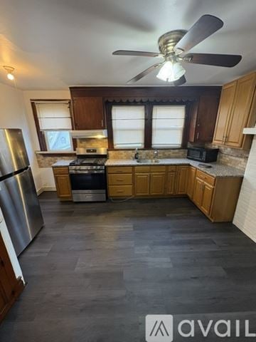 Irvington apartment for rent - A kitchen with wooden cabinets and a stainless steel refrigerator.