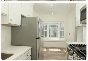 Burbank apartment for rent - A modern kitchen with a stainless steel refrigerator and white cabinets.