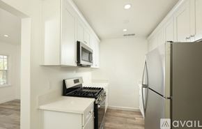 Burbank apartment for rent - A kitchen with white cabinets and a stainless steel refrigerator.