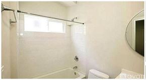 Burbank apartment for rent - A bathroom with a toilet, sink, and a window.