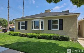 Burbank apartment for rent - A house with a well-maintained lawn and a clear sky above.