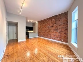 Chicago condo for rent - A room with wooden flooring and white walls.