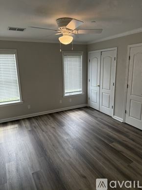 Thomasville townhouse for rent - A room with a ceiling fan and wooden flooring.