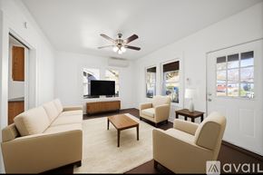 San Antonio house for rent - A living room with a beige sofa, two armchairs, and a coffee table.