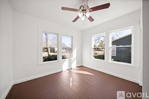 San Antonio house for rent - A room with a ceiling fan and three windows.