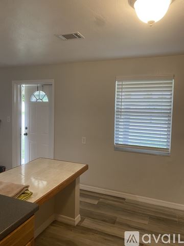 Palm Beach Gardens townhouse for rent - A kitchen counter with a towel on it and a window with blinds.