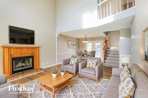 Clarksville house for rent - A living room with a fireplace and a television.