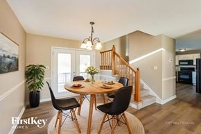 Clarksville house for rent - A dining room with a wooden table and chairs.