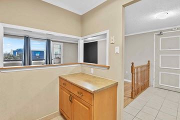 Ottawa apartment for rent - A kitchen area with a wooden counter and cabinets.
