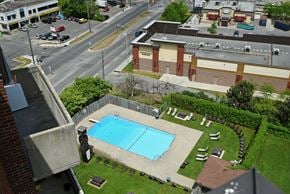 Ottawa apartment for rent - A pool in a backyard with a building in the background.