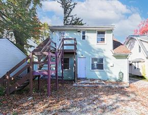Akron apartment for rent - A house with a blue siding and a white door.