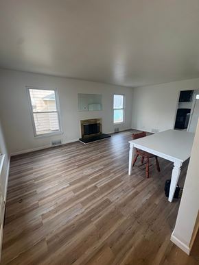 Akron apartment for rent - A room with wooden floors and white walls.